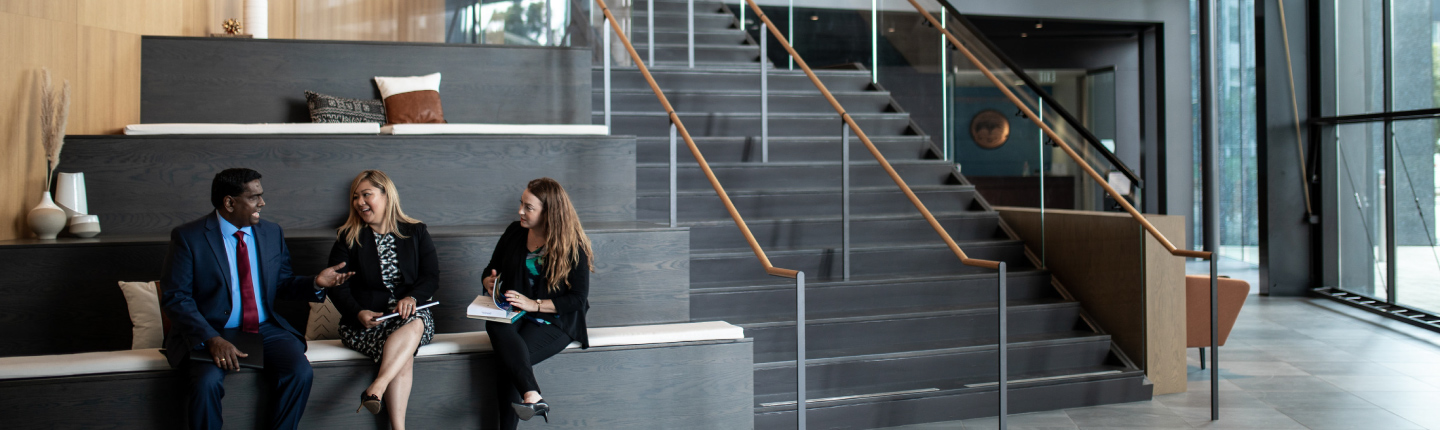Online Master's in Human Resources students talking on the office stairs at Pepperdine University